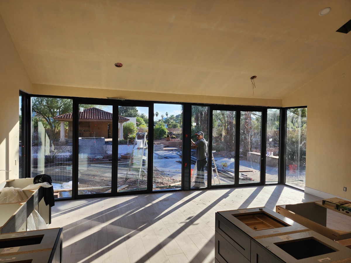Multi-panel black-frame folding glass wall by Mad Touch Glass