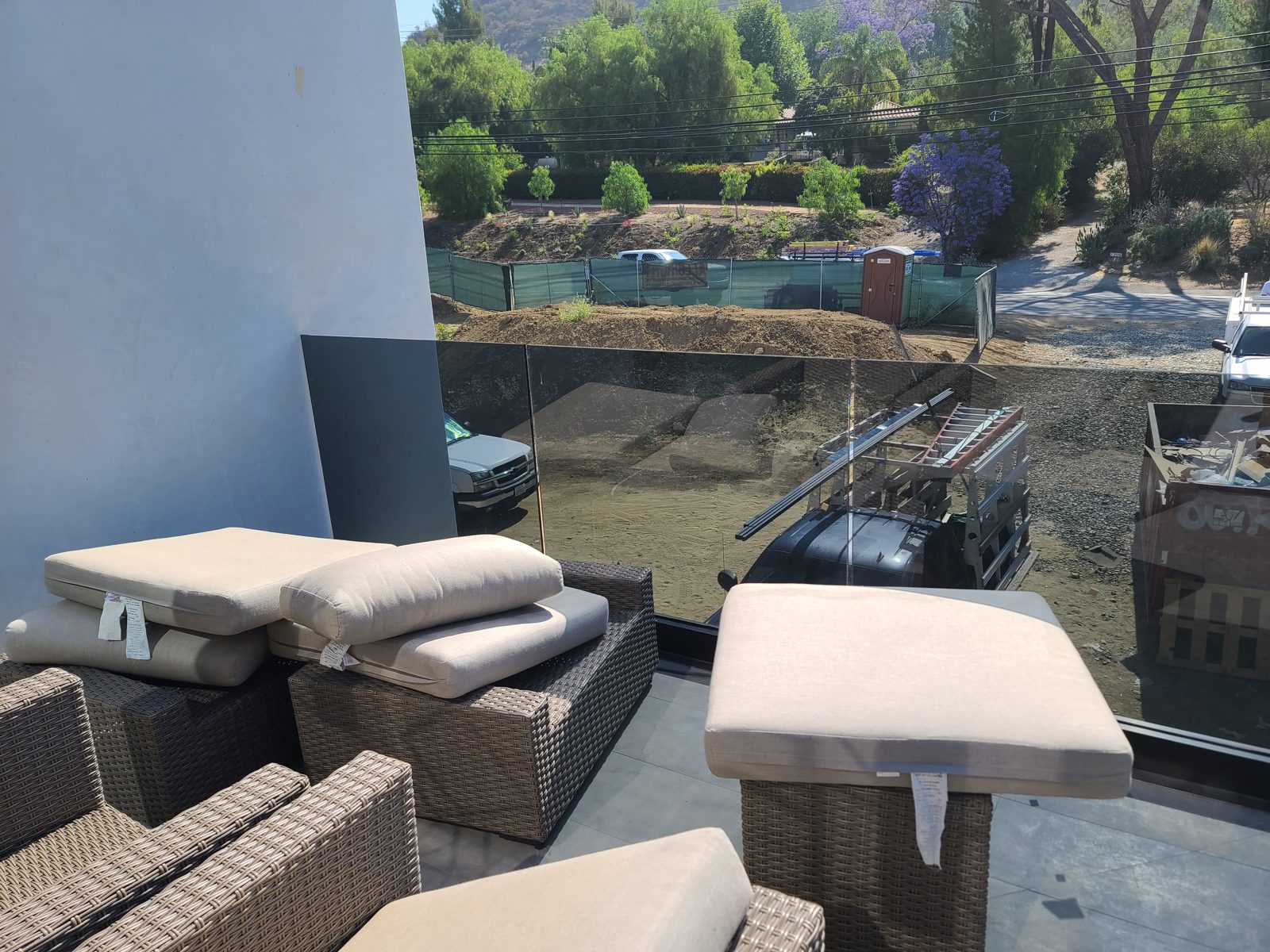 Frameless glass balcony railing overlooking the yard and mountains by Mad Touch Glass