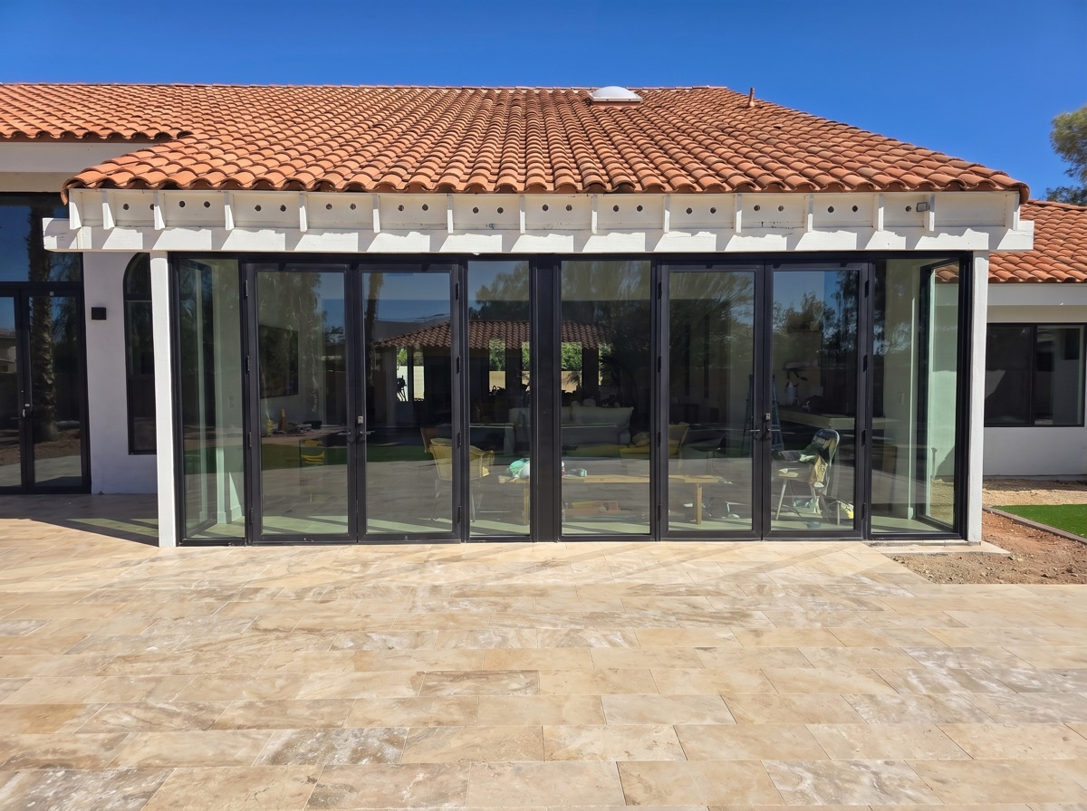 Multi-panel folding glass wall by Mad Touch Glass