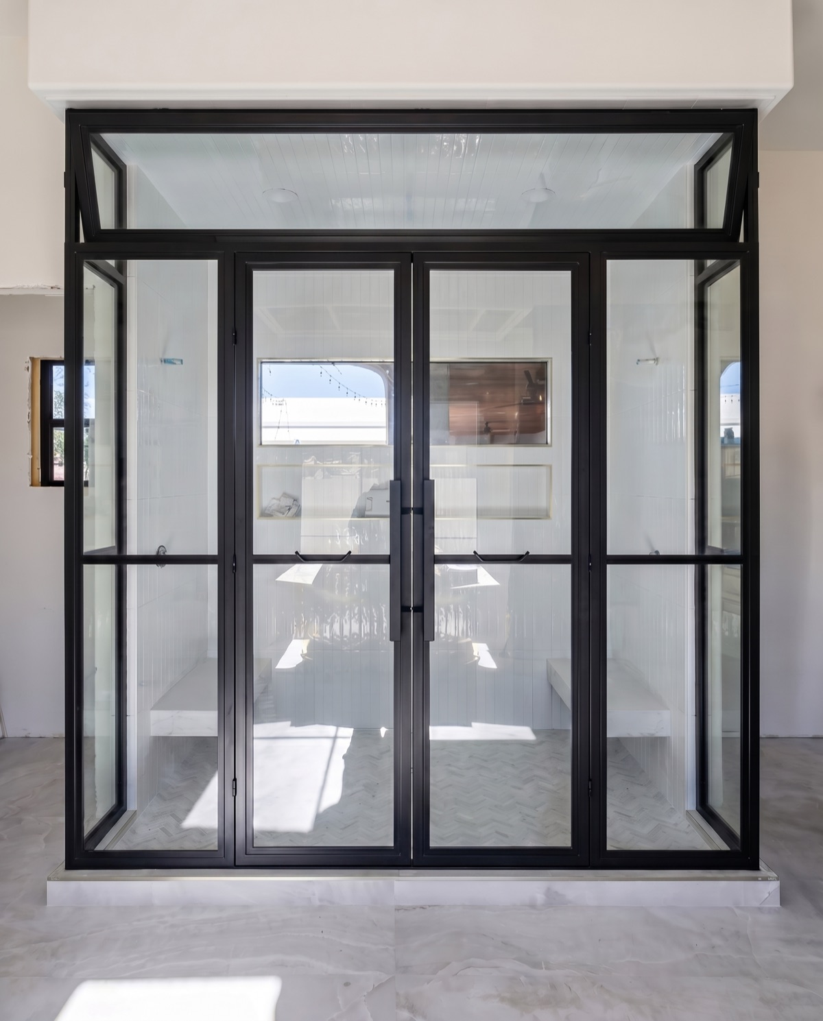 Black steel-grid shower enclosure by Mad Touch Glass
